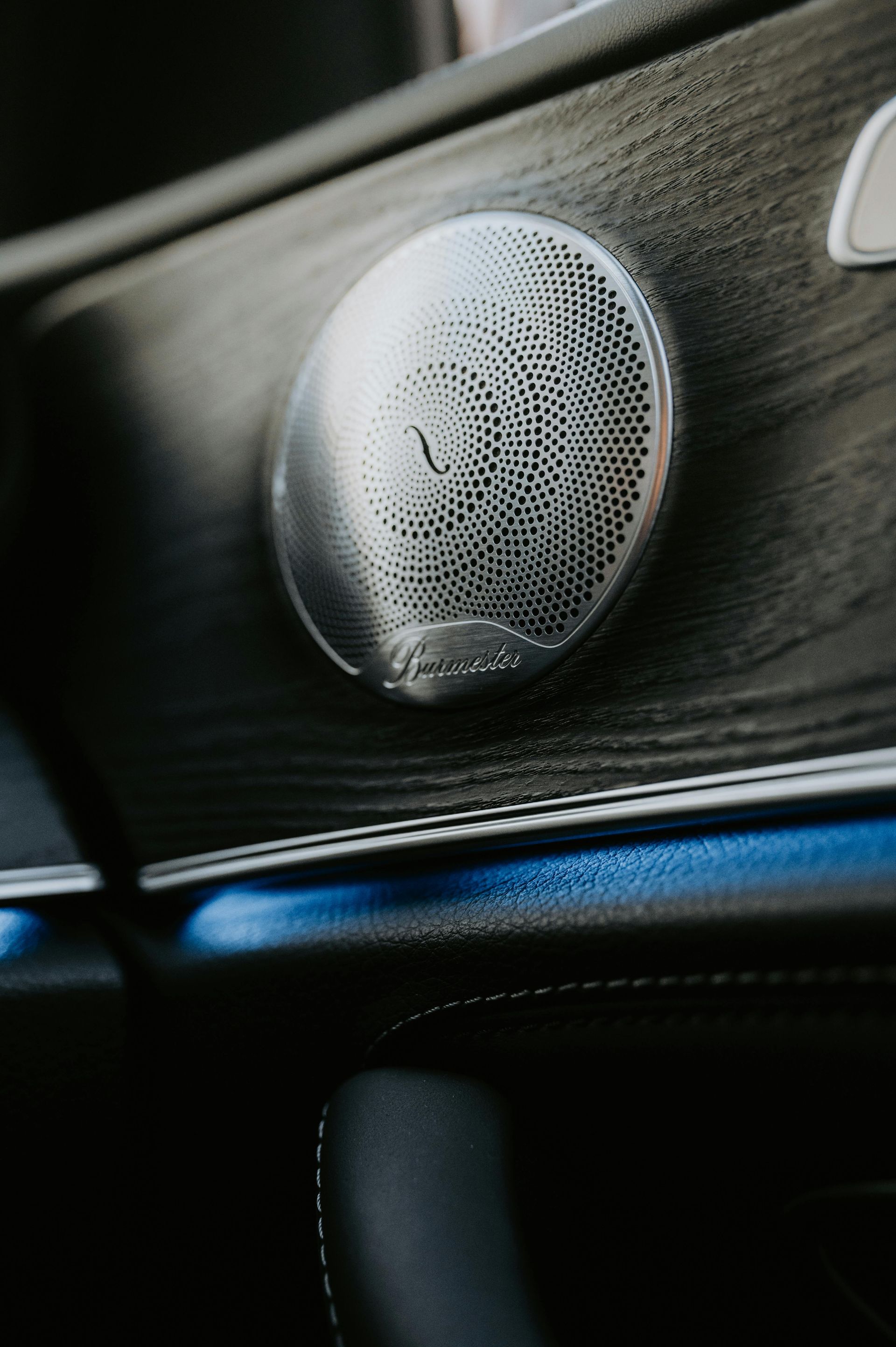 A close up of a speaker in a car.