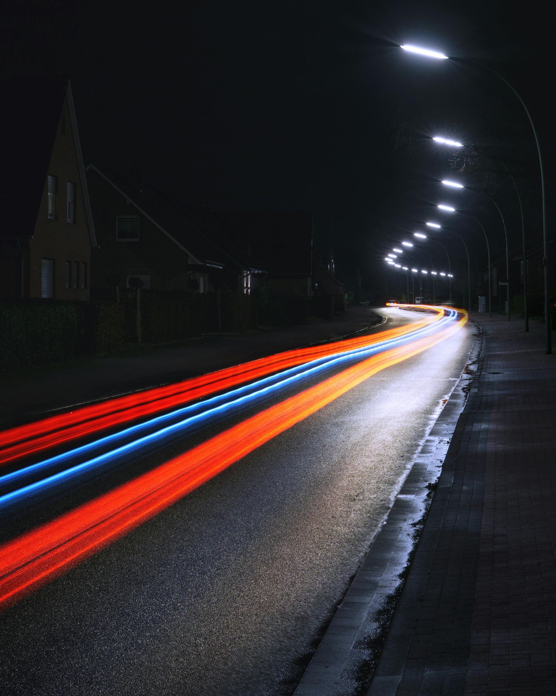 A long exposure photo of a street at night
