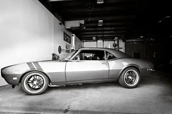 Classic silver coupe parked in a garage, side view. | Sparks Tire & Auto