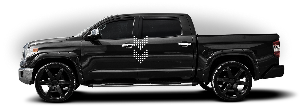 Black pickup truck with large black rims and a white graphic on the door, side view on white background | Sparks Tire & Auto