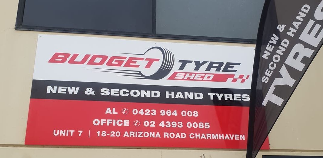 A sign on the side of a building that says budget tyre shed — Budget Tyre Shed In Charmhaven, NSW