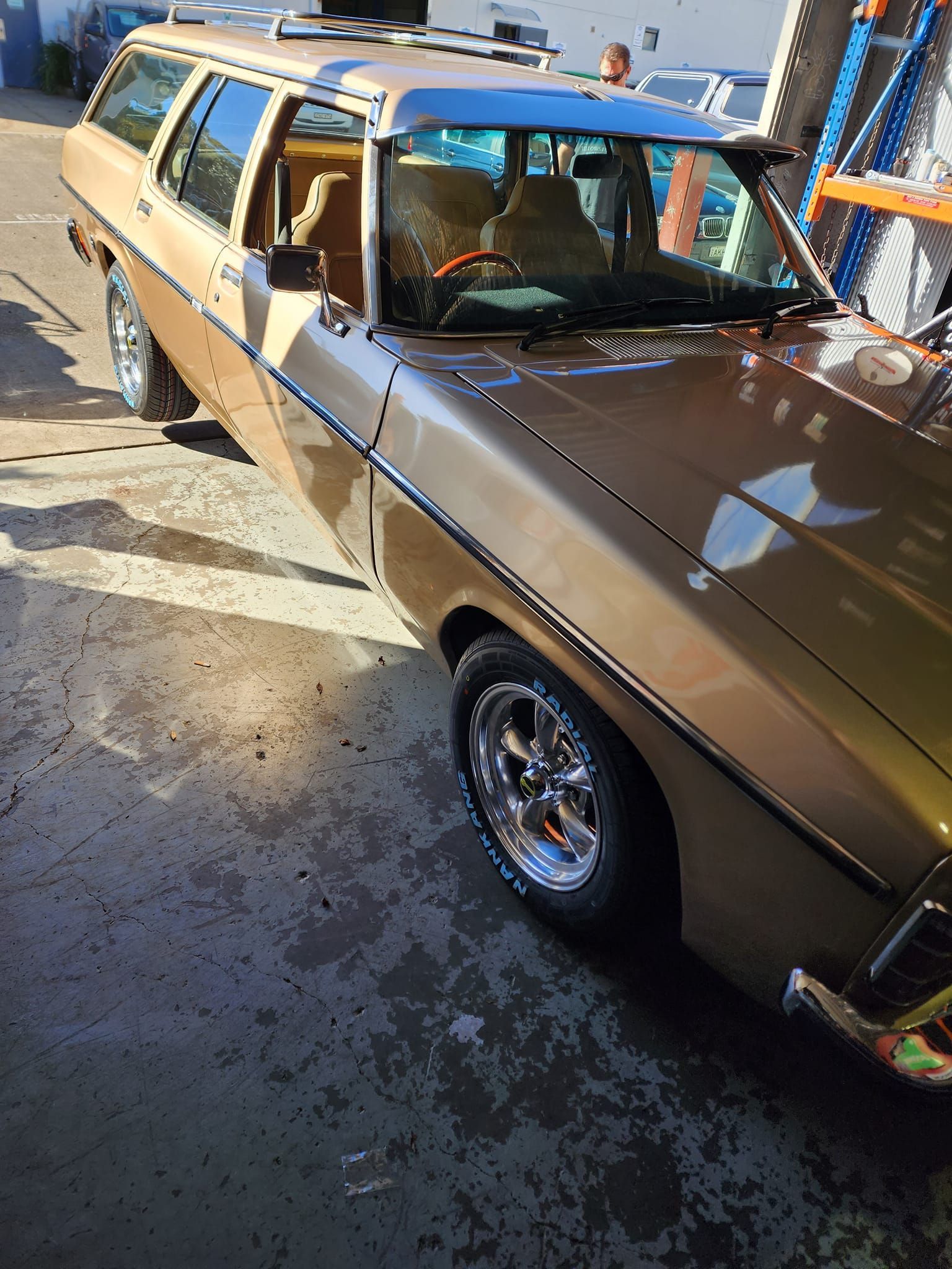 Tan car with shiny wheels parked at Budget Tyre Shed in Charmhaven, providing quality tyres on the Central Coast