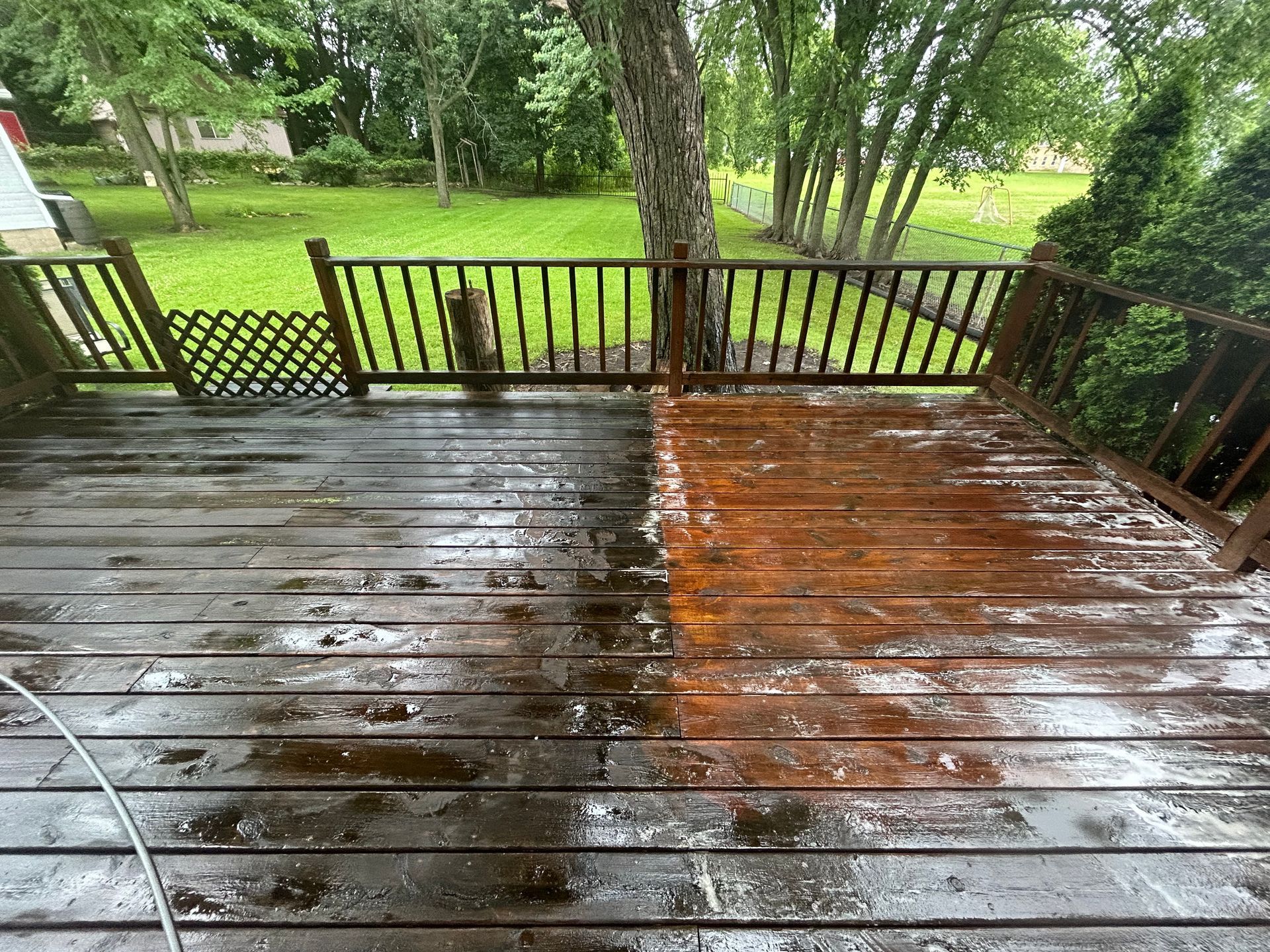 You can see an image of a wooden backyard deck during a Deck Washing service in Lincolnshire, with one half freshly cleaned and restored to a brighter wood finish while the other half remains darker and dirty from buildup and moisture.