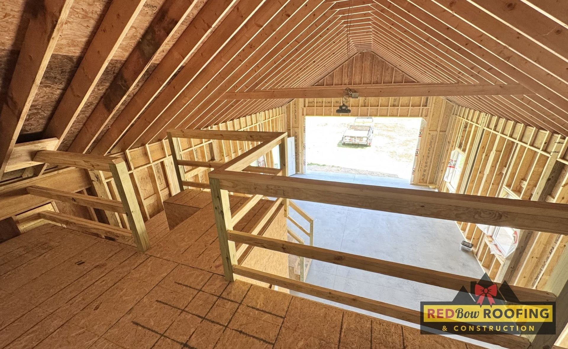 Interior of an unfinished wooden roof framing with open beams and a skylight opening