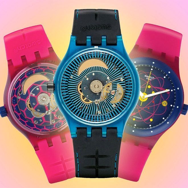 Three colorful Swatch watches: pink and blue, showing watch mechanisms.