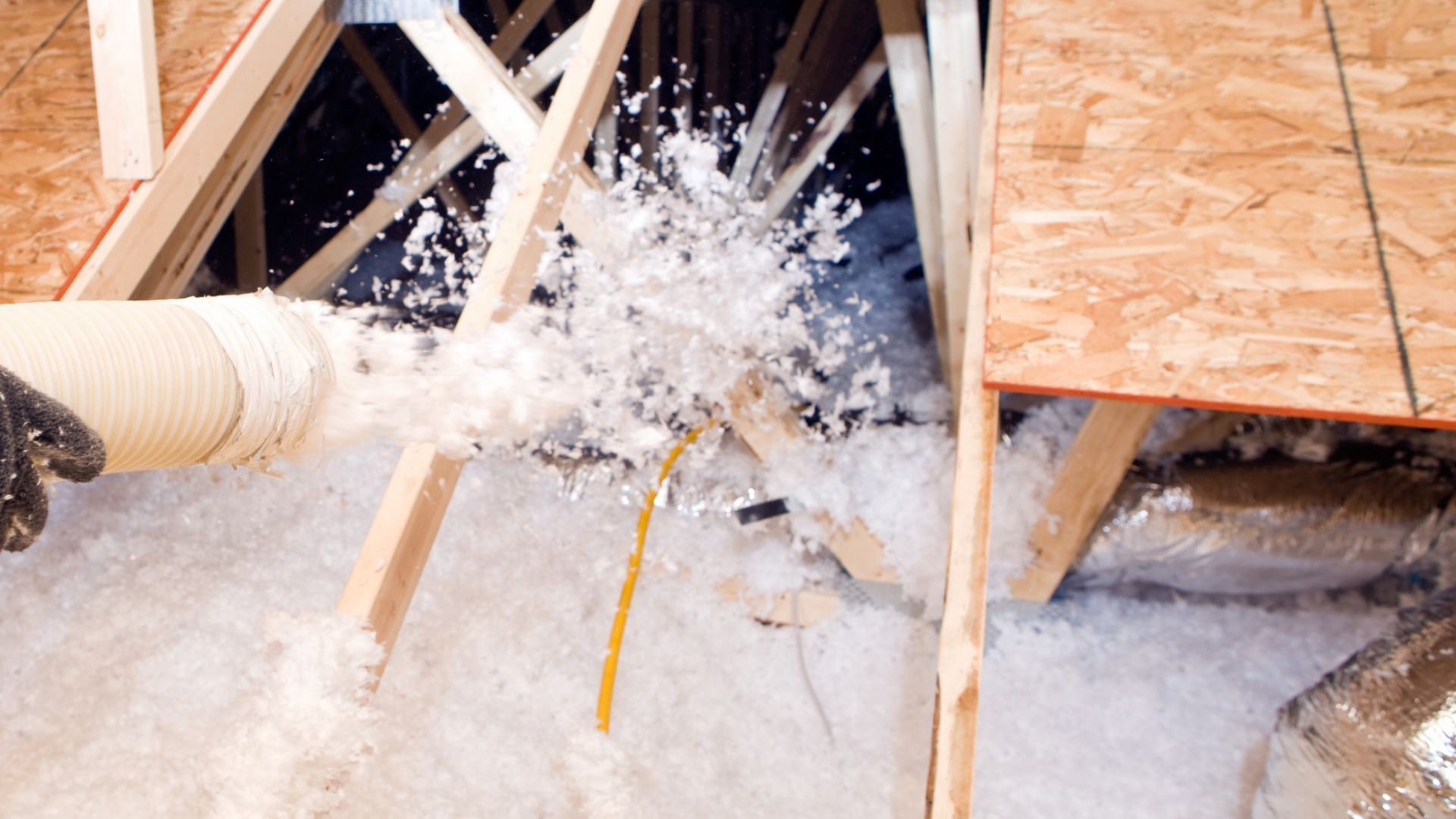 Crawl space with professionally installed spray foam insulation covering the underside of the floor for improved thermal protection.