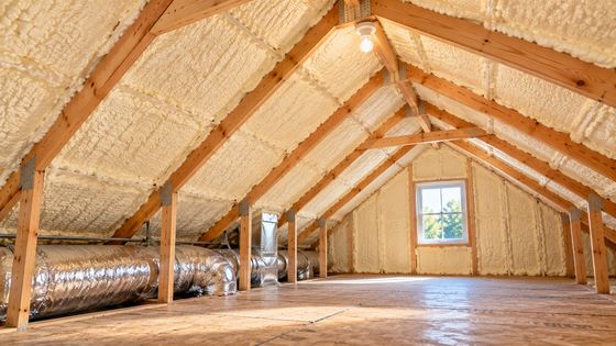 Completed attic spray foam insulation in Tyler, Texas, featuring insulated roof rafters, exposed wooden framing, HVAC ductwork, and a clean attic interior.