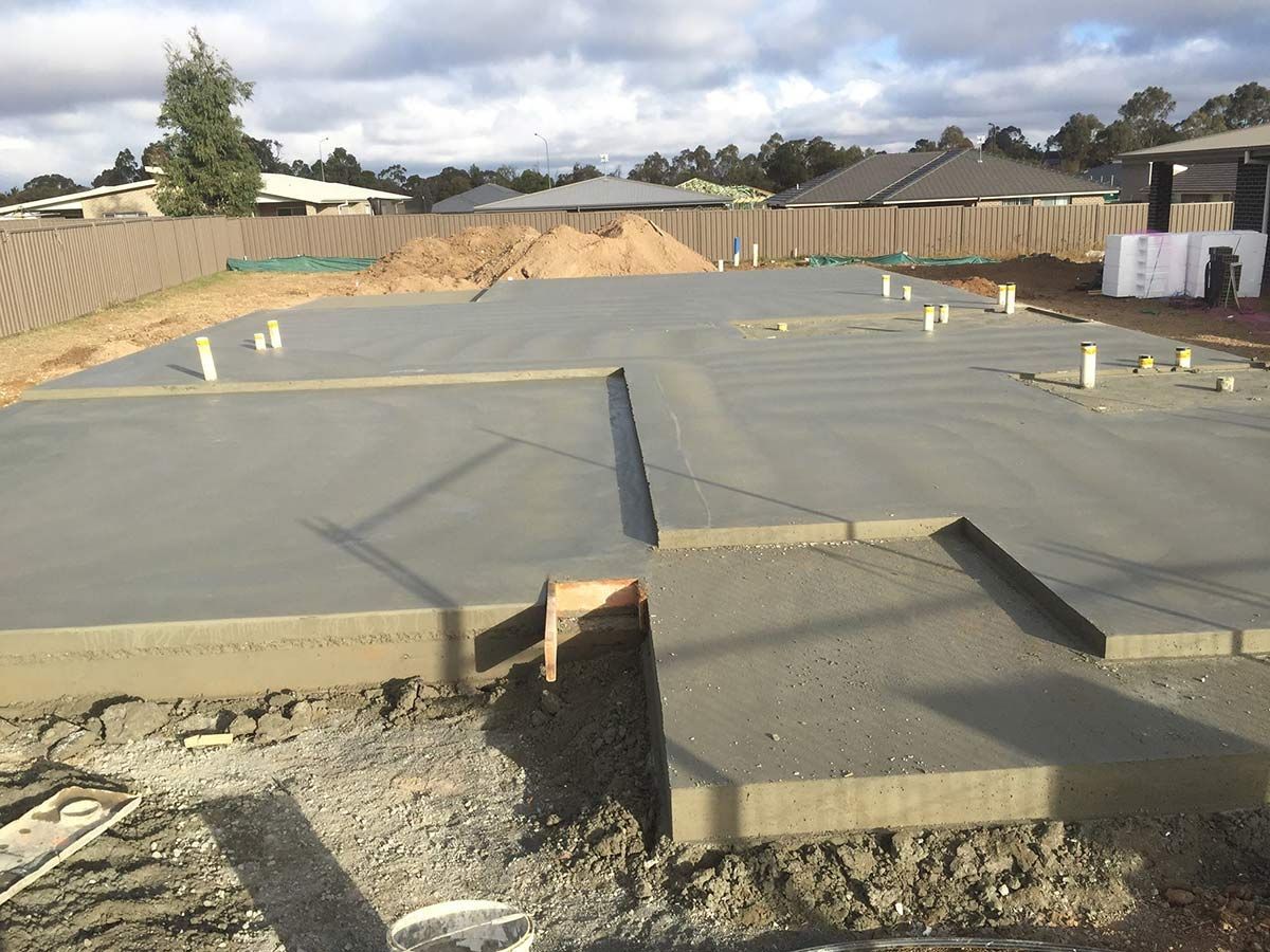 A Concrete Floor is Being Built in the Backyard of a House — Heritage Concrete In Uralla, NSW