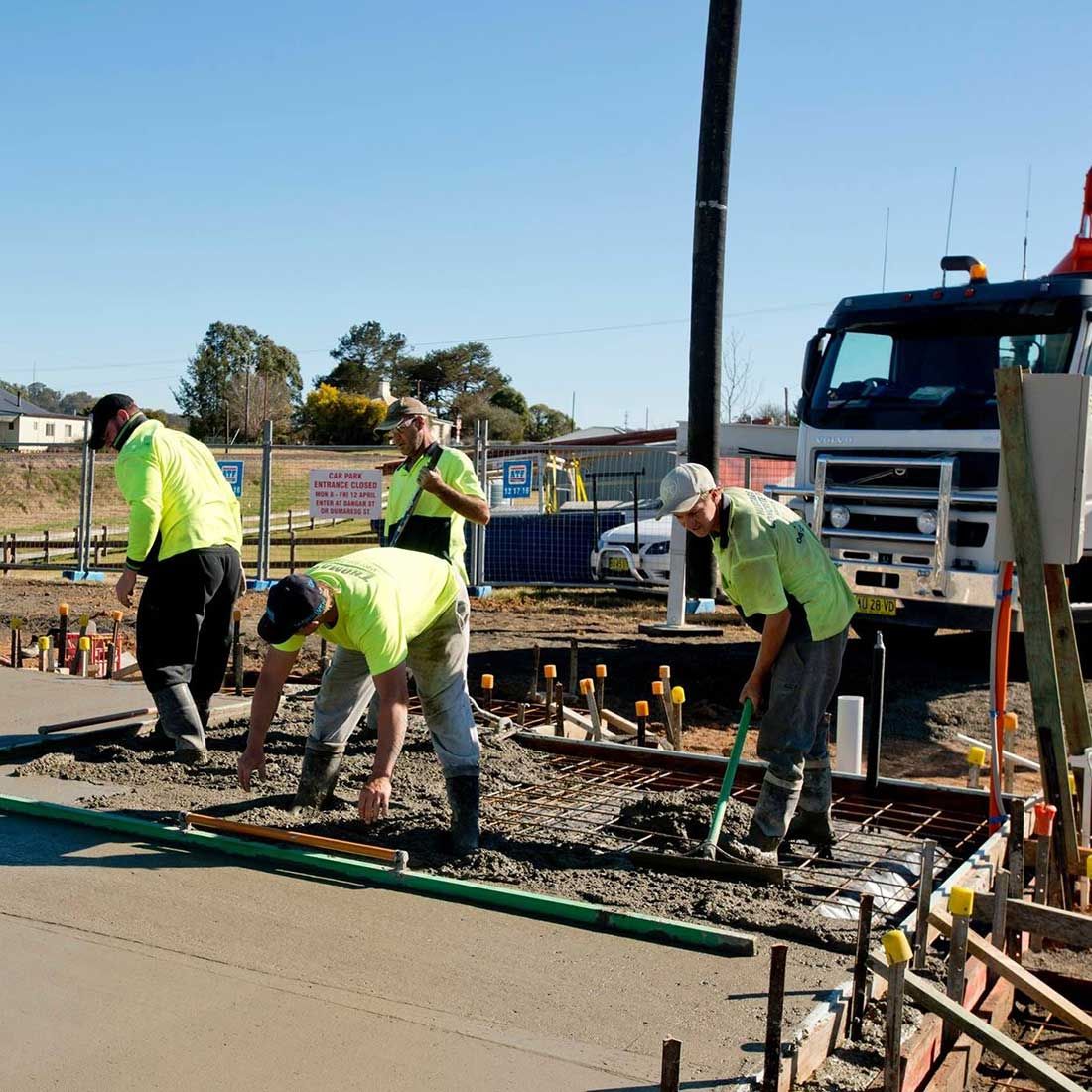A Group of Construction Workers Are Working on a Road — Heritage Concrete In Uralla, NSW