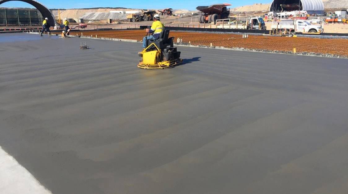 A Man is Working on a Concrete Road — Heritage Concrete In Uralla, NSW
