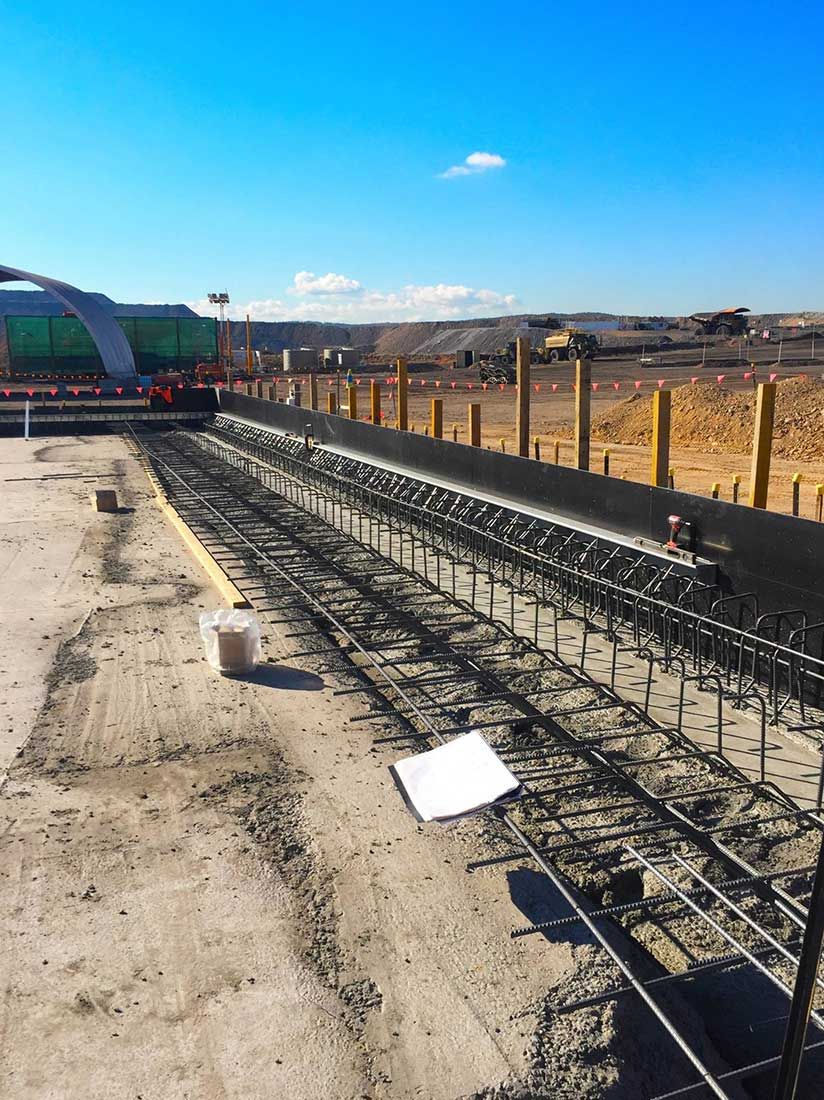 A Construction Site With a Lot of Steel Bars and a Blue Sky in the Background — Heritage Concrete In Uralla, NSW