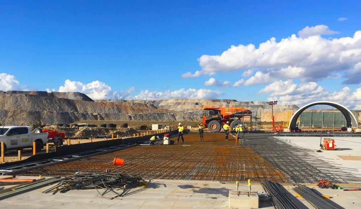 A Group Of Construction Workers Are Working On A Construction Site — Heritage Concrete In Uralla, NSW