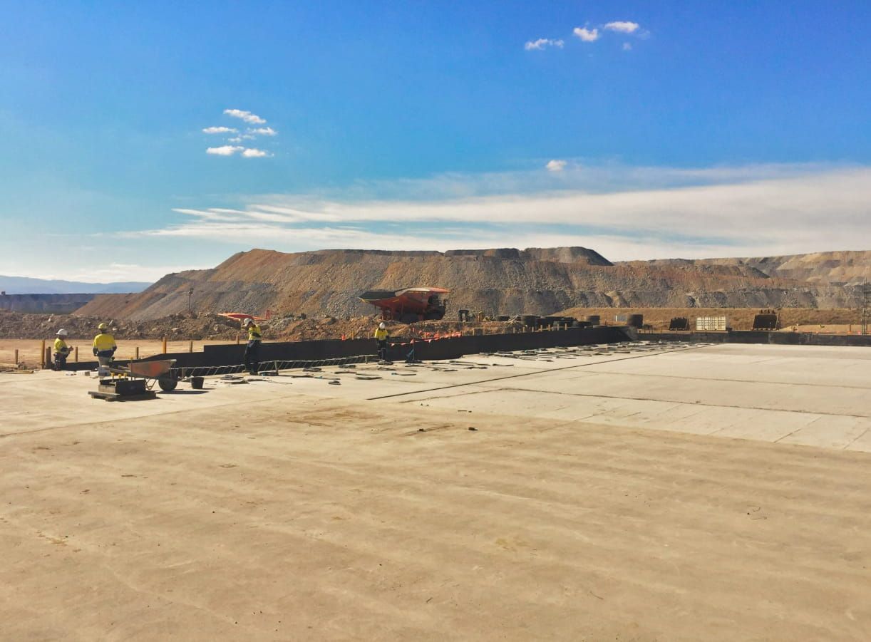 A Large Dirt Field With A Mountain In The Background — Heritage Concrete In Uralla, NSW