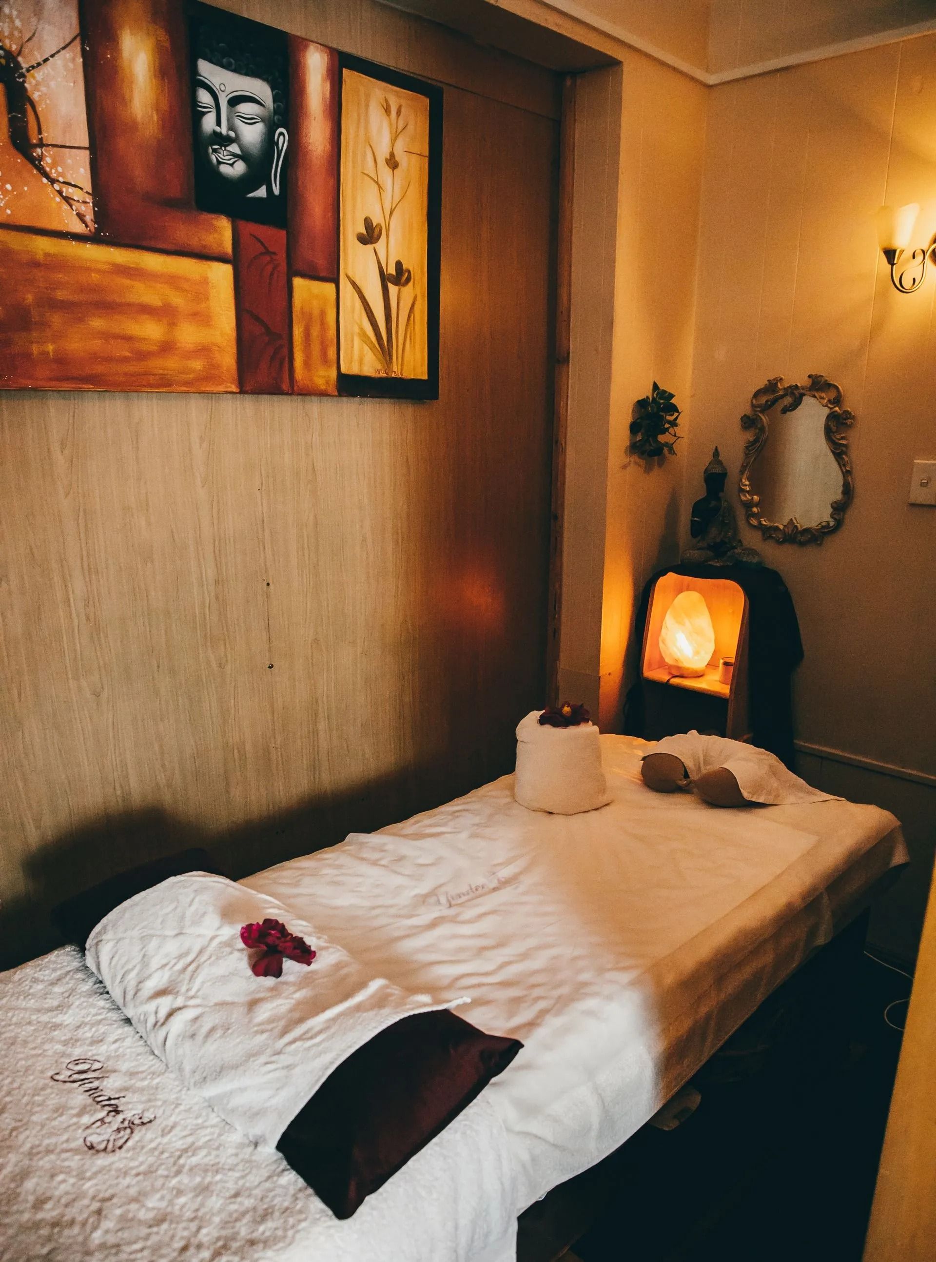 Massage Room With a Bed, Artwork, and Soft Lighting — Traditional Massage Services In Broadbeach, QLD