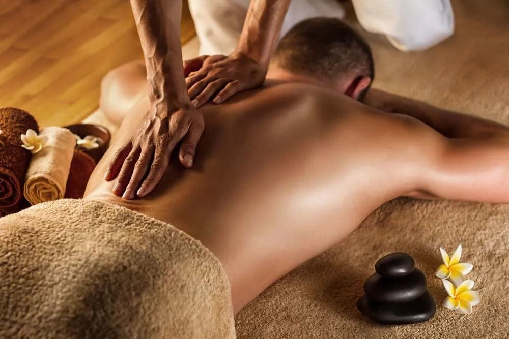 Man having a Back Massage at a Spa; Hands of Massage Therapist on His Back — Traditional Massage Services In Broadbeach, QLD