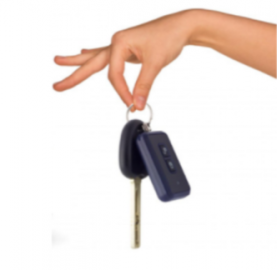 Hand holding car keys and a remote fob.