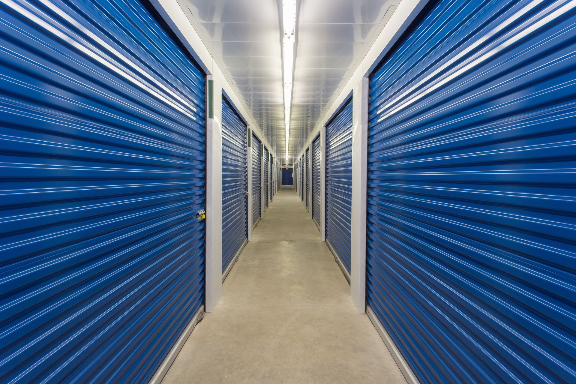 The interior of a self-storage facility showing the individual storage unit metal roll up doors The interior of a self-storage facility showing the individual storage unit metal roll up doors