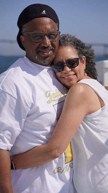 A man and a woman are hugging each other on a boat.