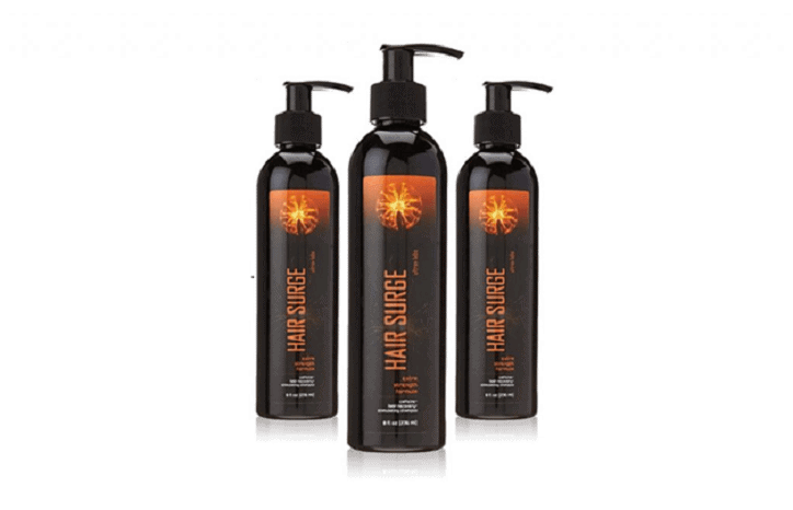 Three bottles of hair surge are sitting next to each other on a white surface.