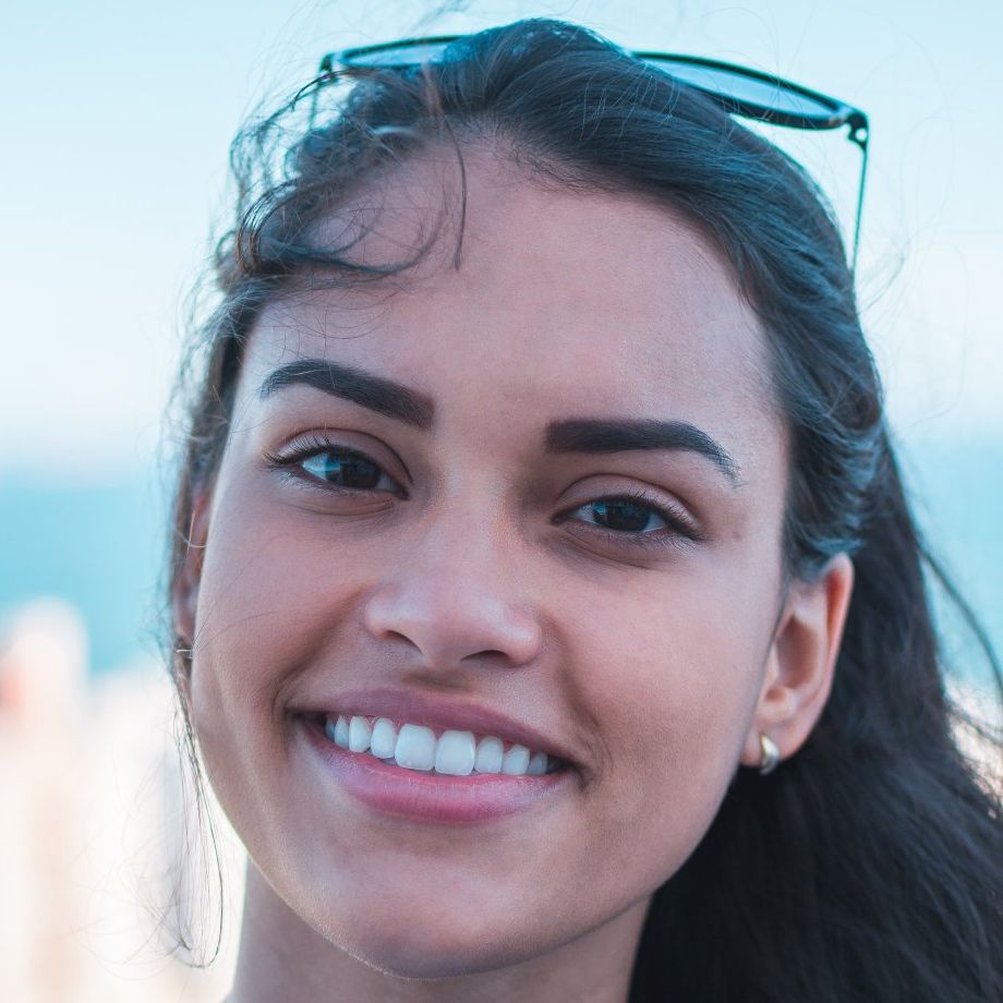 a close up of a woman 's face with sunglasses on her head .