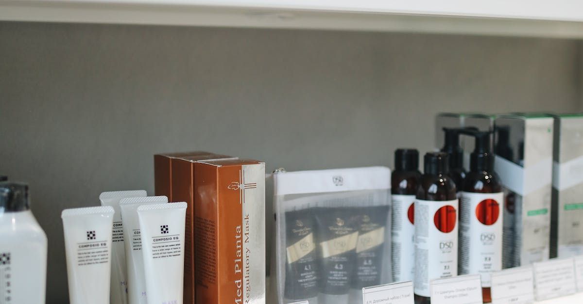 A shelf filled with bottles and tubes of cosmetics.