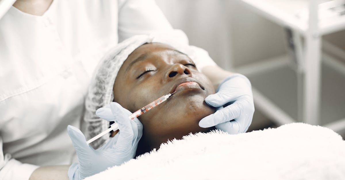 A woman is getting a botox injection in her face.