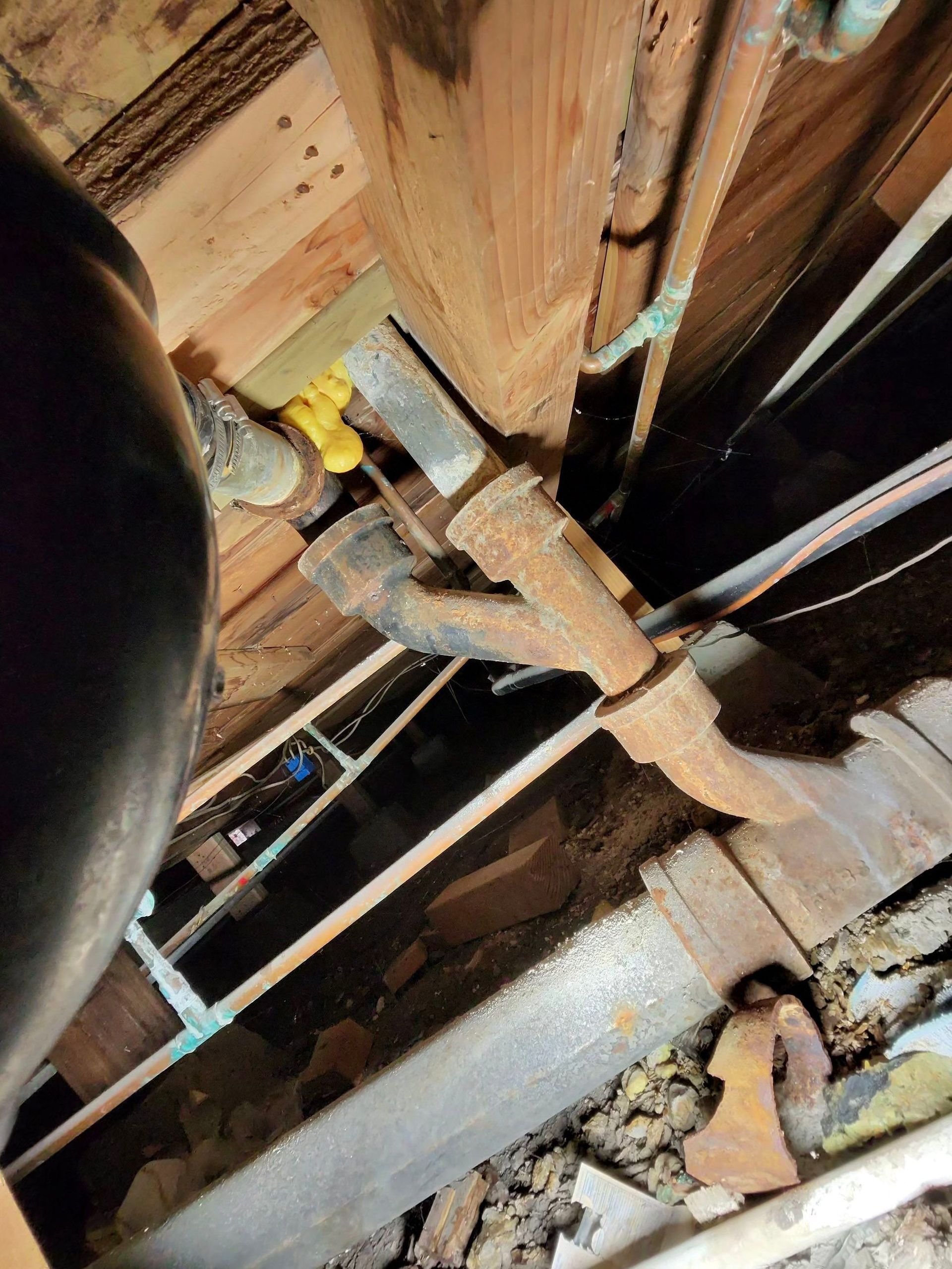 Close-up of damaged wooden beams and debris inside a collapsed structure