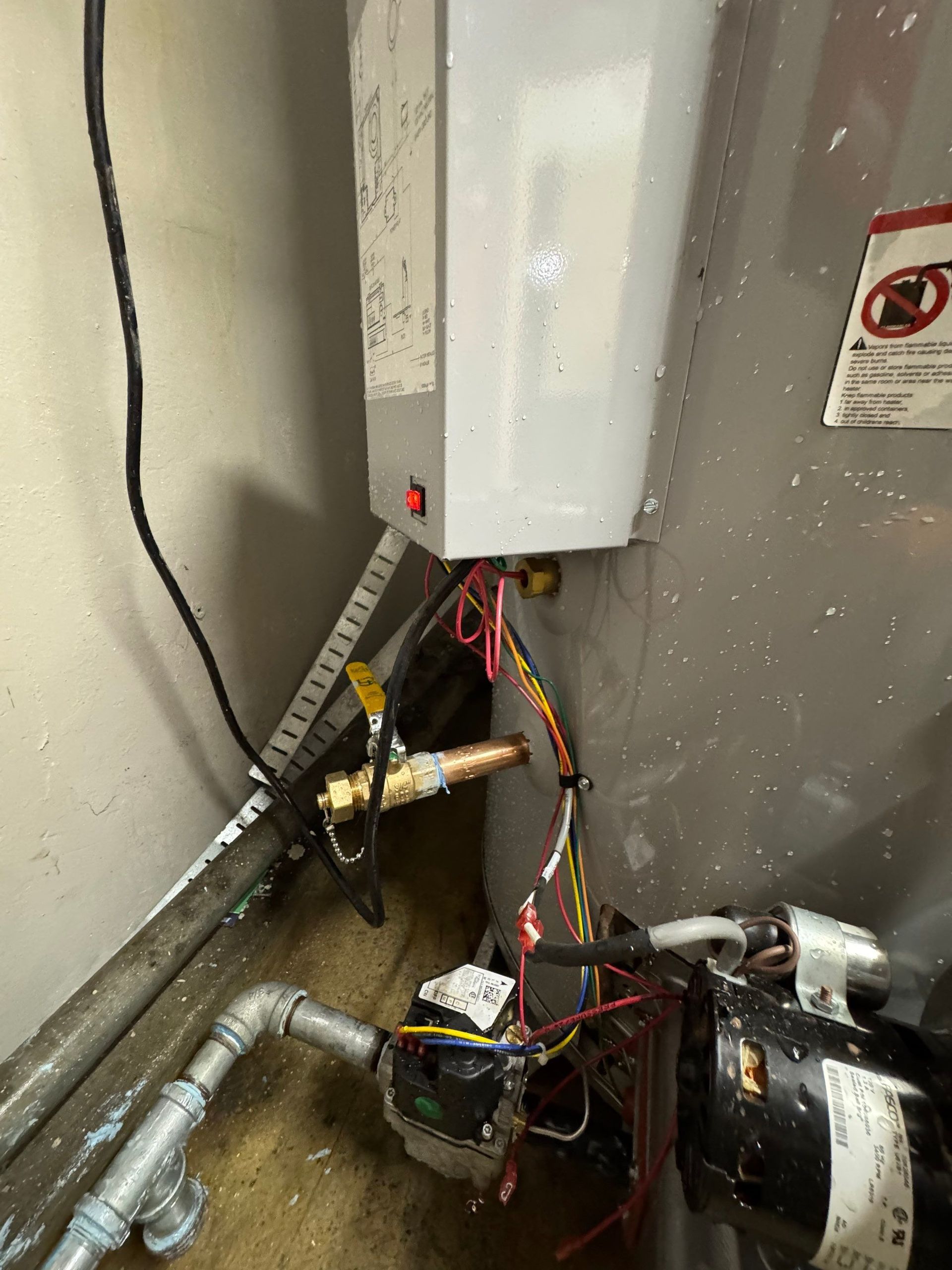 Exposed plumbing and wood framing beneath a sink, with a yellow-circled pipe joint.