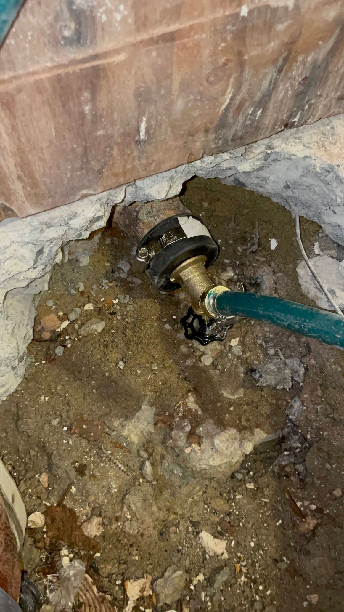 Blue water pressure gauges and brass pipe fittings in a utility area