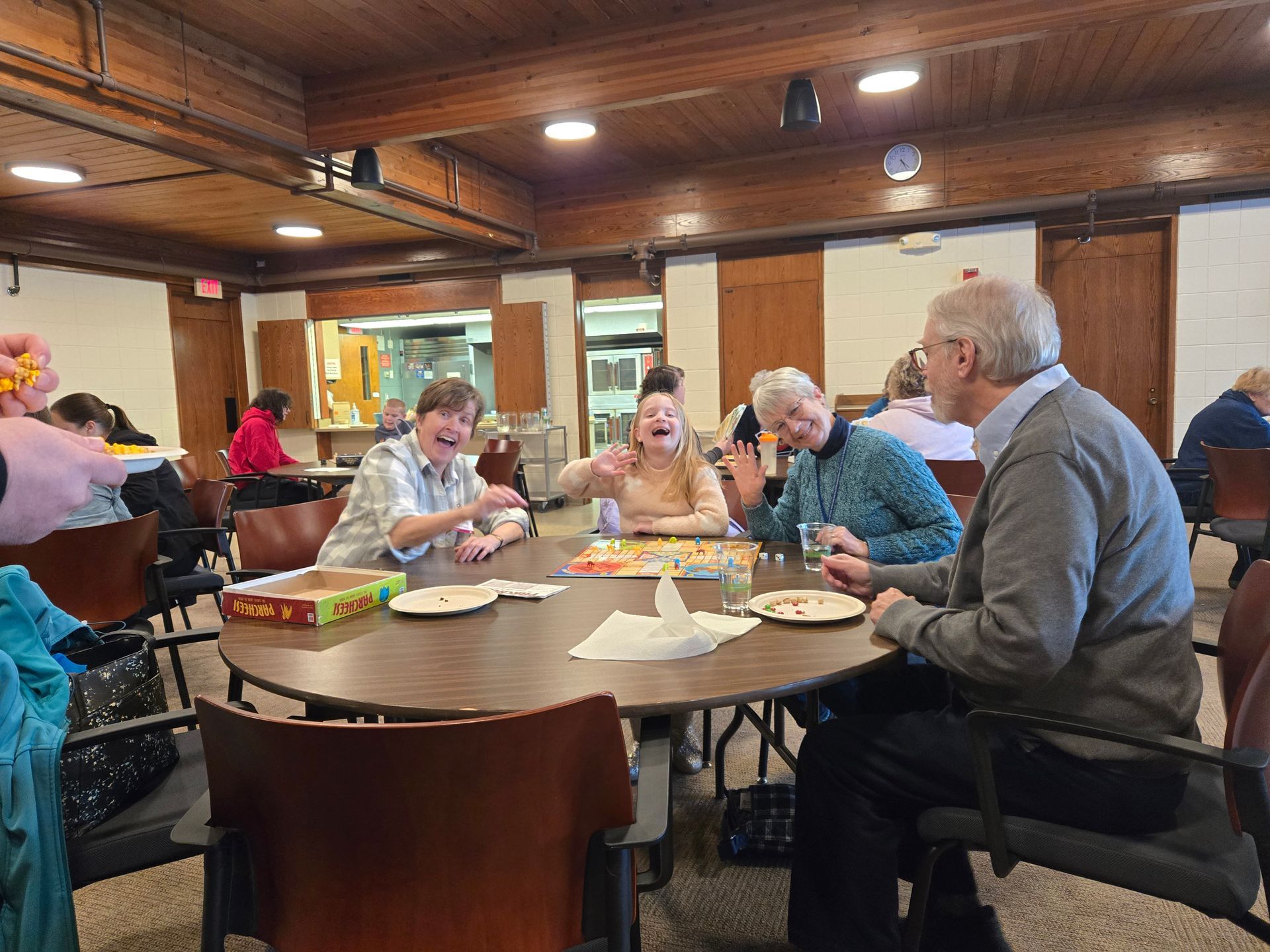 people laughing while playing card and board games