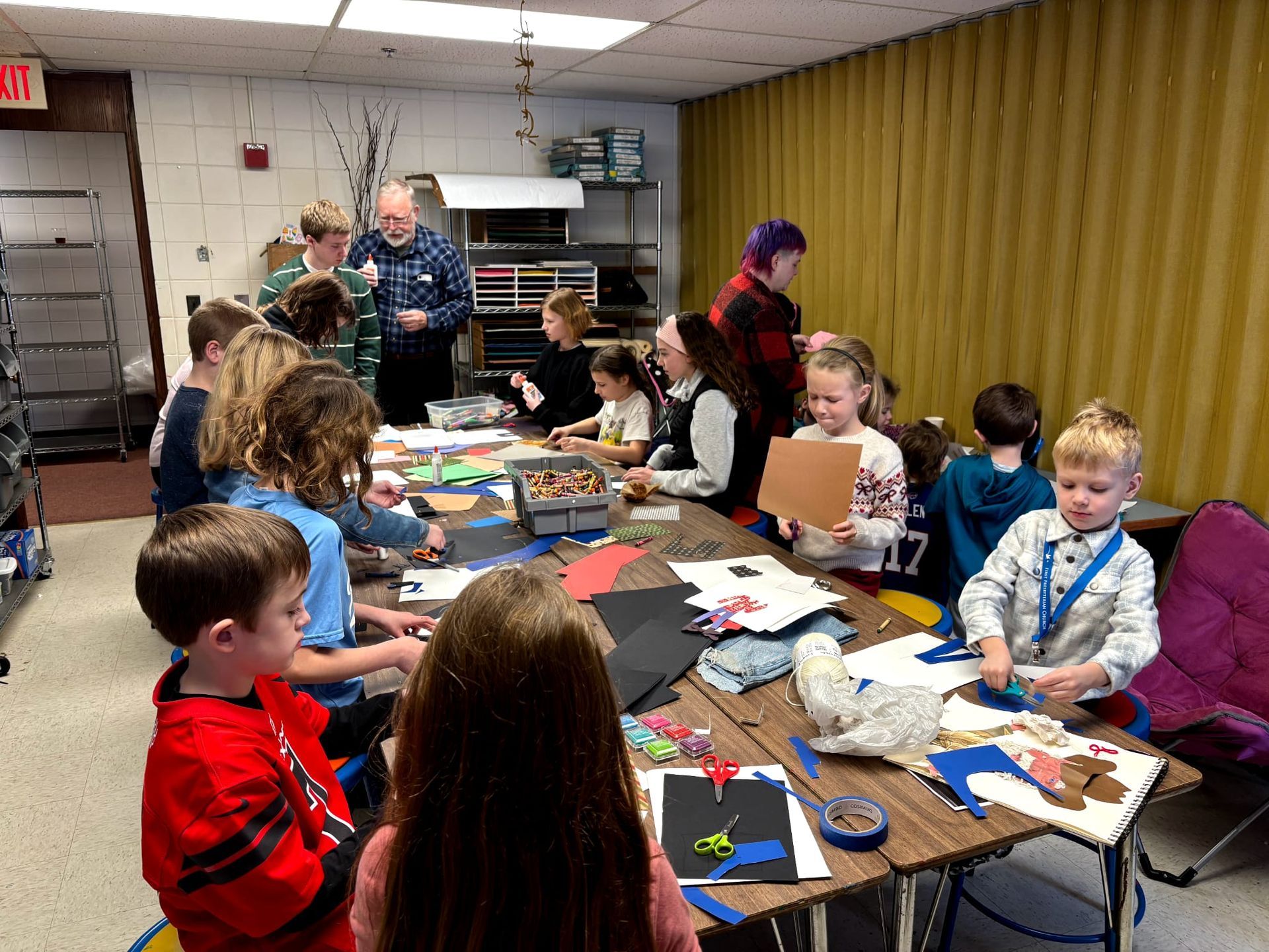 art studio full of kids making a collaborative art project