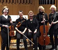 A group of women standing next to each other holding musical instruments.