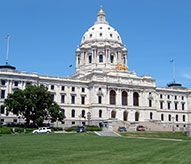 A large white building with a dome on top of it.