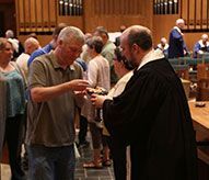 A man is taking communion during church service