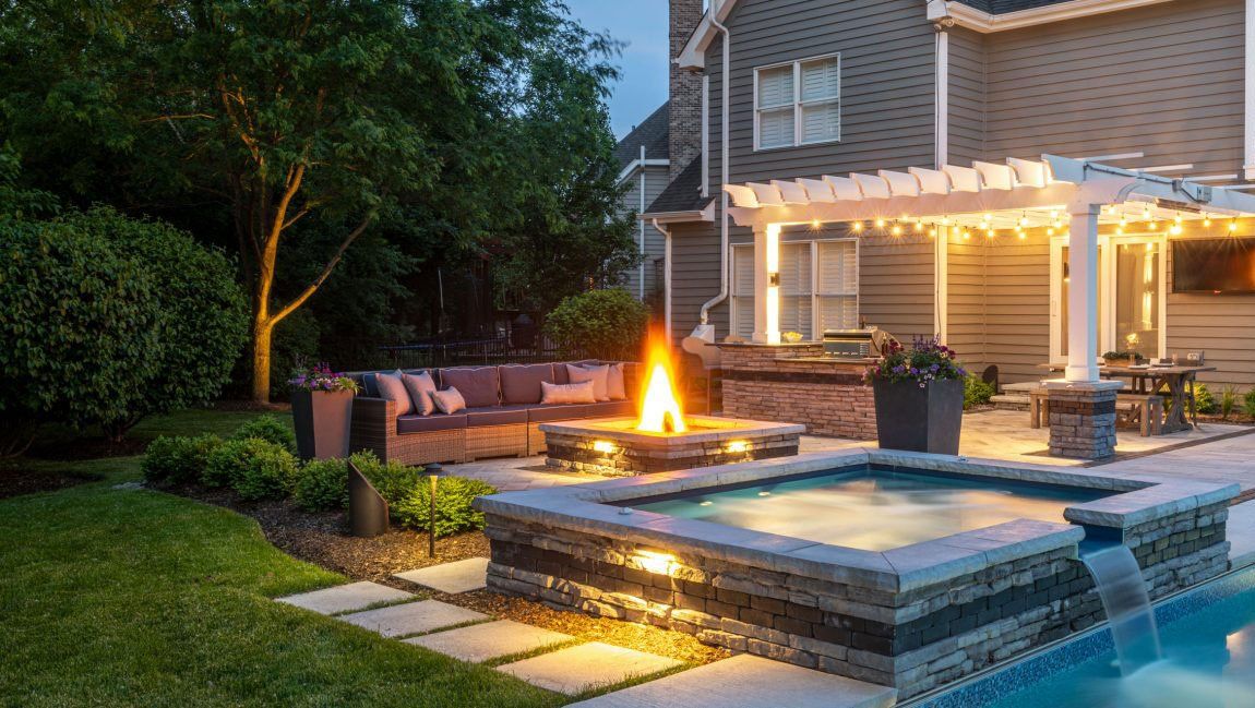 Shear waterfall curtain scupper water feature in Ohio backyard patio.