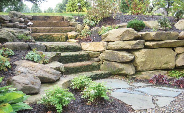 Natural landscape stone barnstone steps and wall in Geneva Ohio