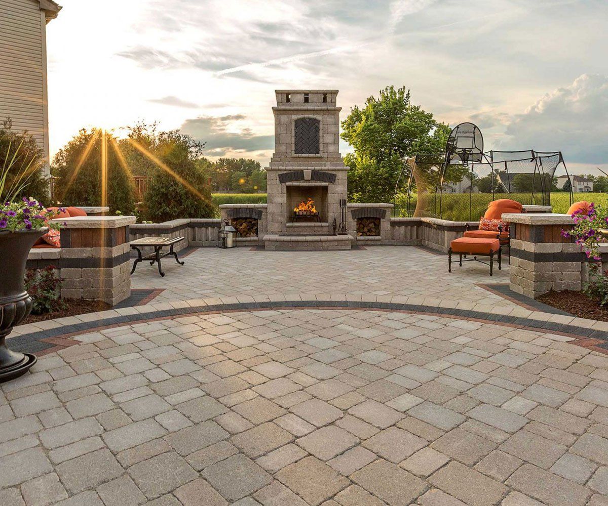 Unilock paver patio Paved patio with outdoor fireplace in Ohio backyard