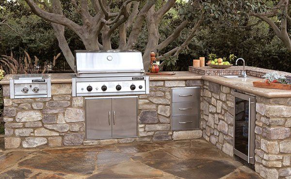 Easy install outdoor kitchen in Ohio landscape patio with built in grill, outdoor refrigerator, and countertop.