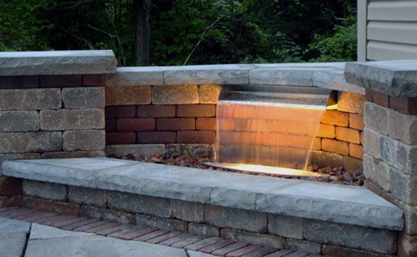 Ohio backyard with calming water feature waterfall on patio.