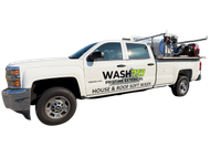 White service pickup truck with “WASH” and “House & Roof” signage, carrying ladders and equipment on top