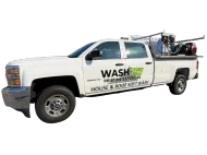 White service pickup truck with “WASH” and “House & Roof” signage, carrying ladders and equipment on top