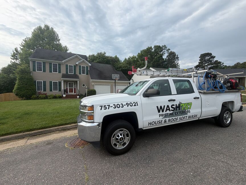 White WASH service truck parked on a suburban street in front of a house