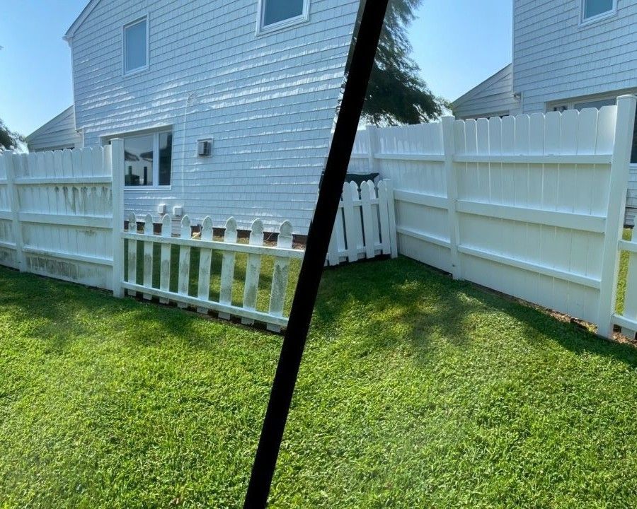 White vinyl fence beside a light blue house and green lawn, split by a dark diagonal bar.