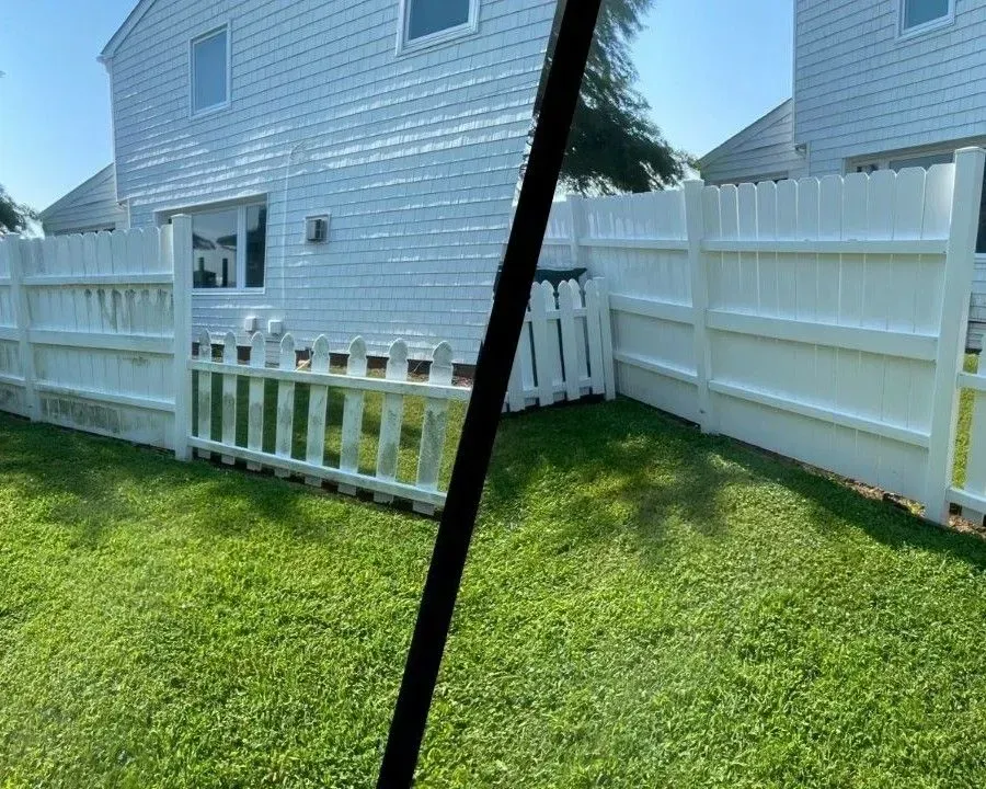 White vinyl fence beside a light blue house and green lawn, split by a dark diagonal bar.