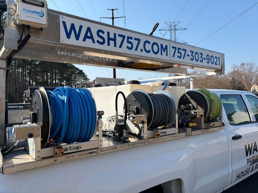 Service truck with hose reels and a boom lift labeled WASH757.COM and a phone number.