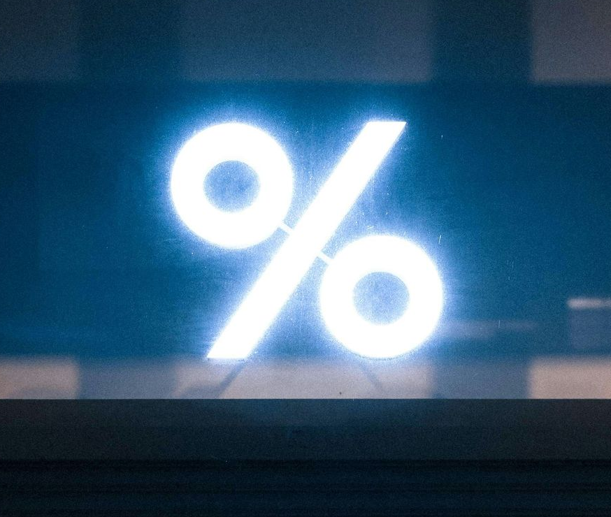 Percentage symbol on a purple and blue gradient background.