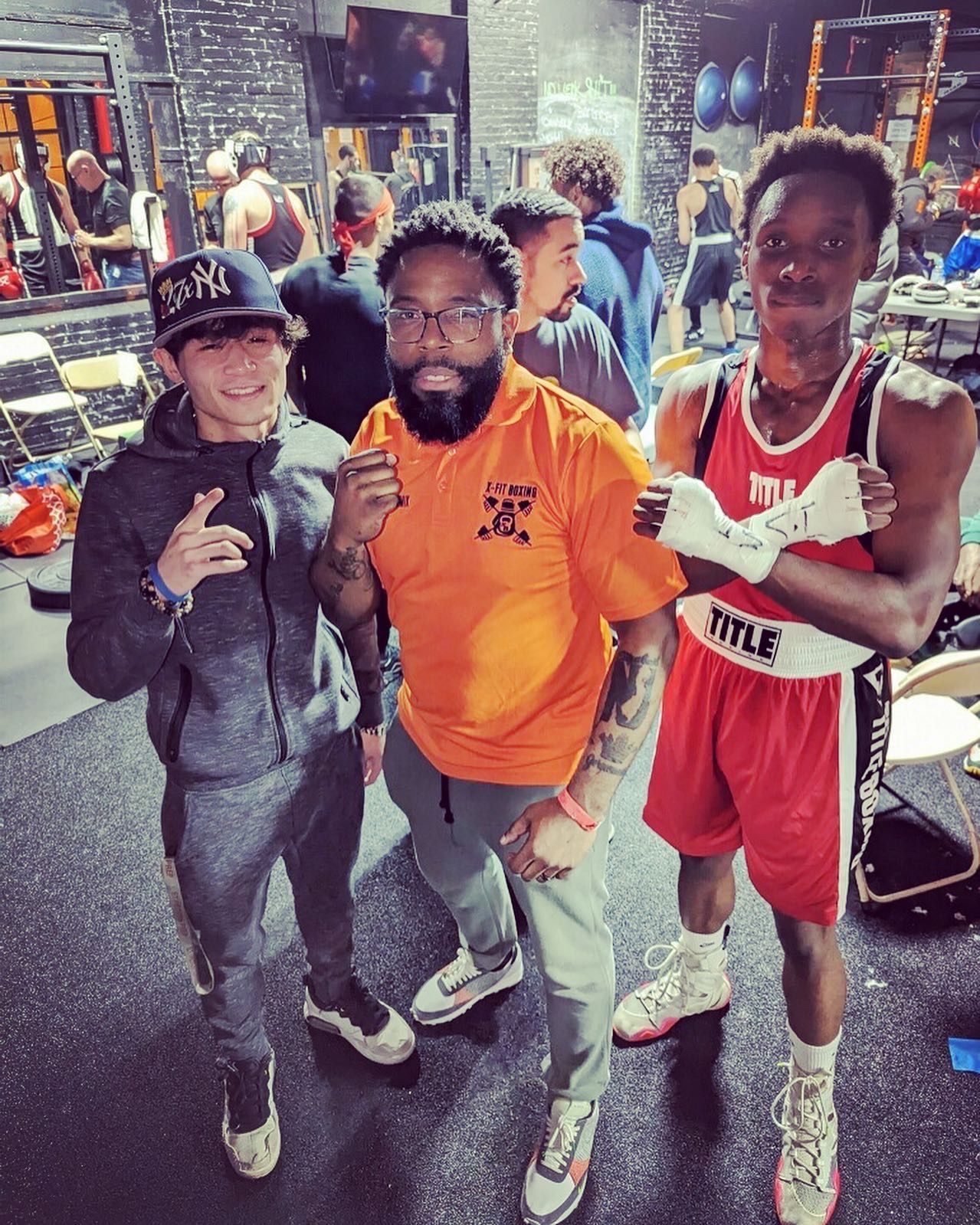 A group of men are posing for a picture in a gym.