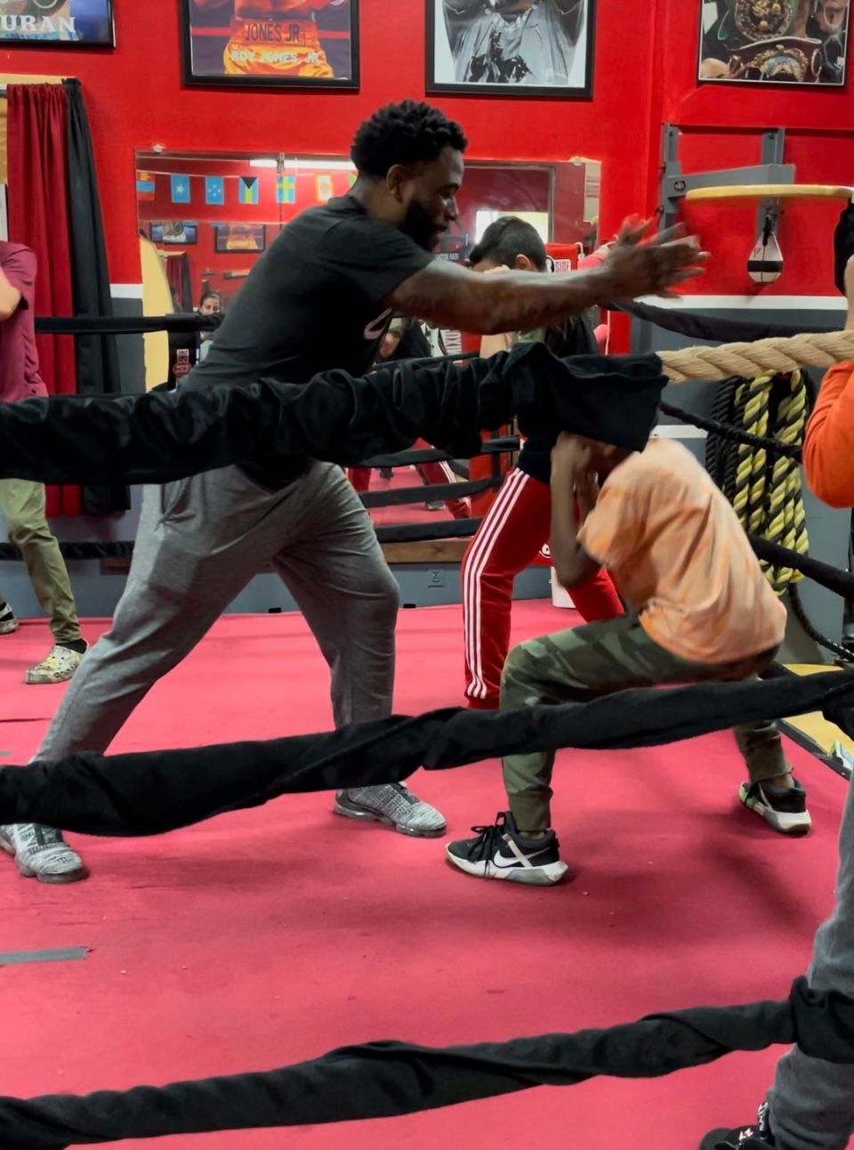 A group of people are boxing in a boxing ring.
