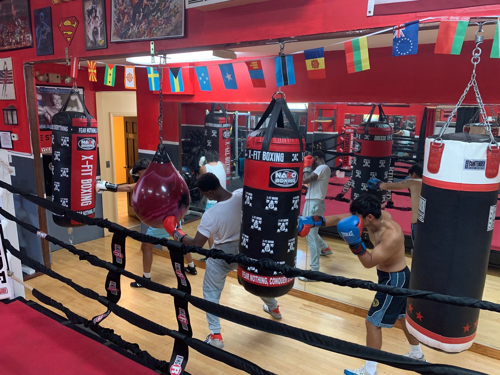 A group of men are boxing in a boxing ring.