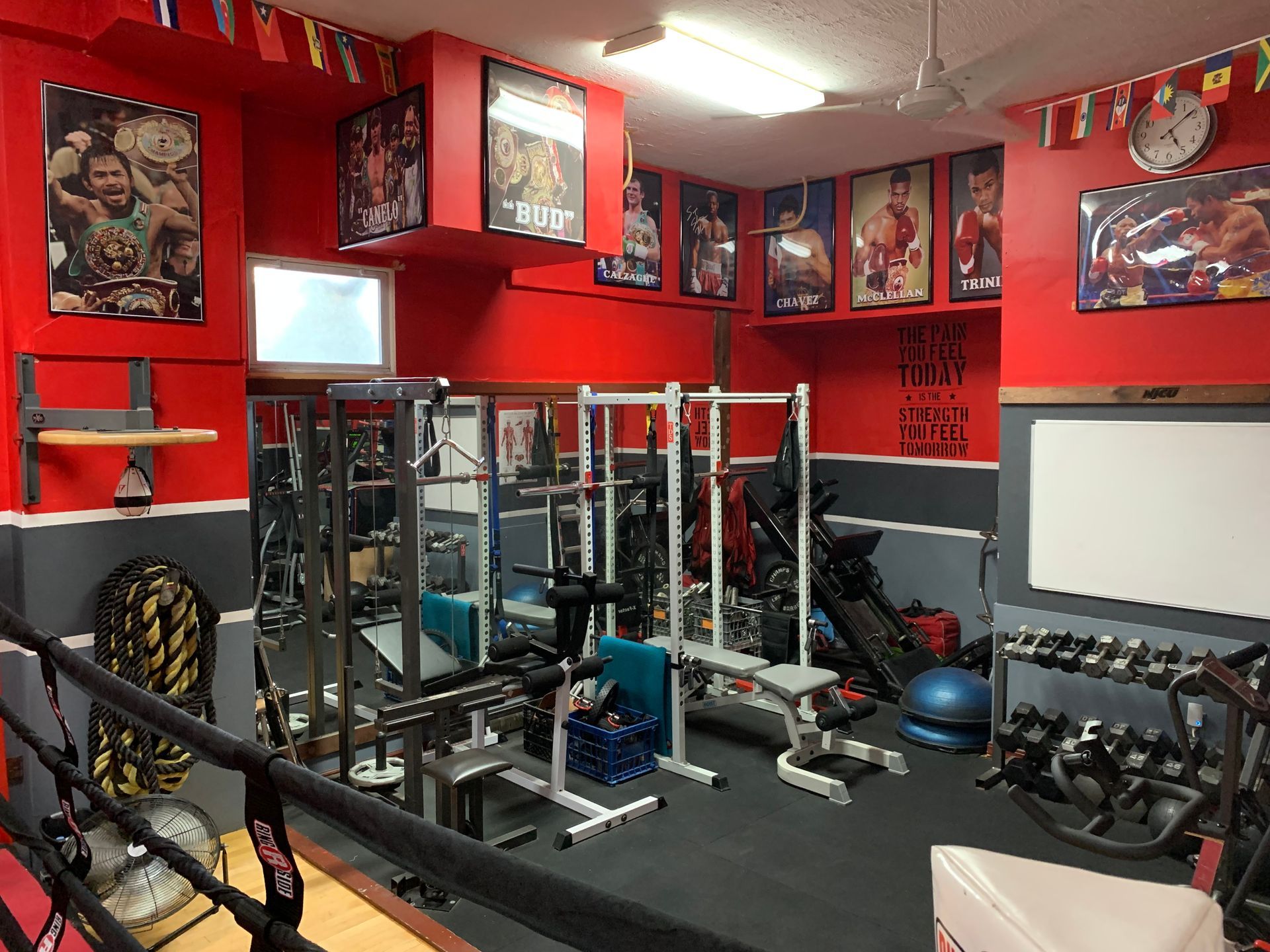 A gym with red walls and a lot of exercise equipment